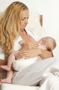 Woman breast feeding with implants