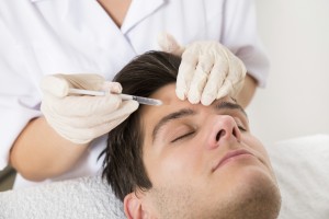 Young Man Having Botox Treatment At Beauty Clinic