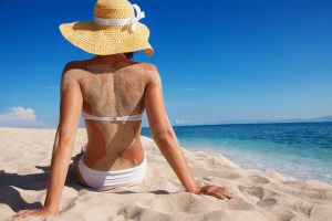 beautiful woman relaxing on sandy beach alone