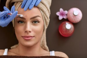 woman receiving facial injection dermal filler botox