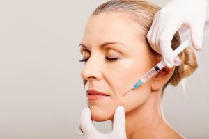dermal filler injected into middle aged woman's cheek